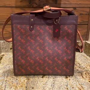 COACH field tote in burgundy/red with iconic carriage pattern throughout.